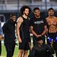 Colin Kaepernick, center, stands with Bruce Ellington, Brice Butler, Jordan Veasy, and Ari Werts during the Colin Kaepernick NFL workout held at Charles R. Drew High School on Nov. 16, 2019, in Riverdale, Ga.